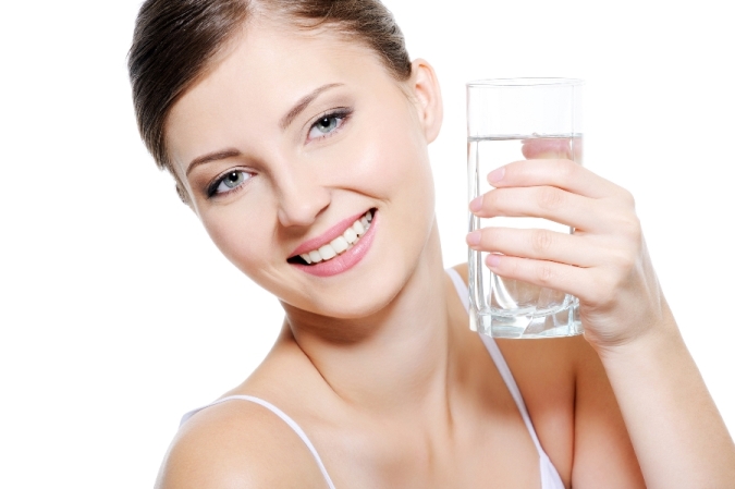 Happy woman with a glass of water